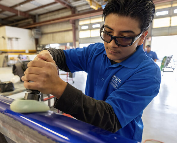 auto collision & management technology student buffing vehicle in Waco
