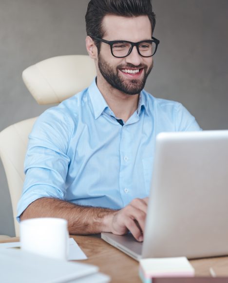 Caucasian male sitting at a laptop