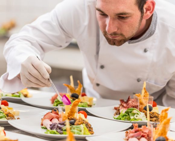 Chef garnishing his appetizer plate