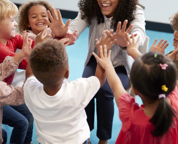 Black female teacher with students