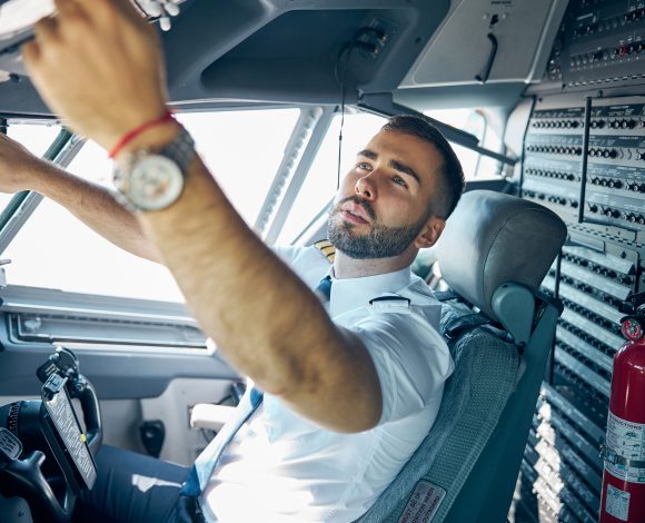 Male caucasian pilot in cockpit