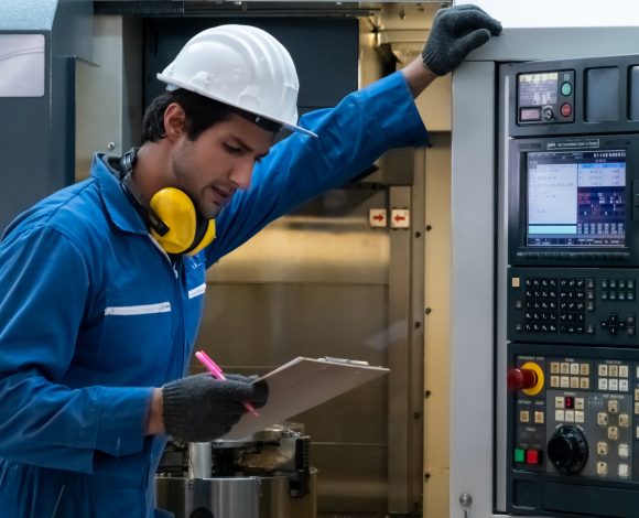 Hispanic male automation technician at control panel