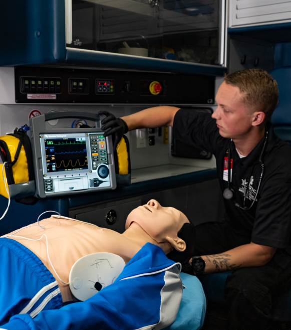 EMS student working in ambulance simulator.