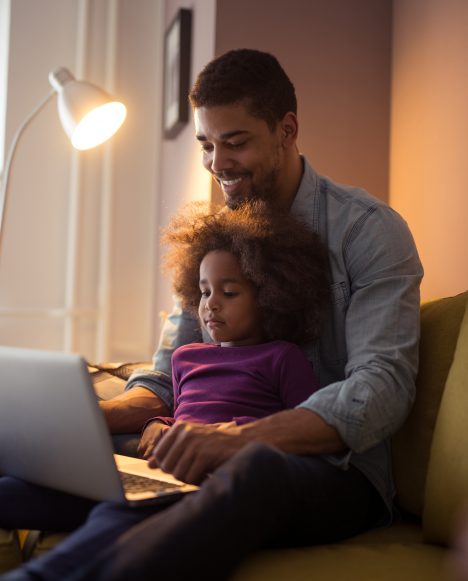 Black male with daughter on laptop | Adult Learners