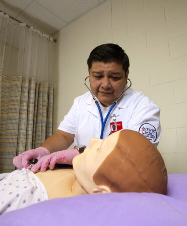 Alex Zuniga, nursing student, practicing hands-on training.