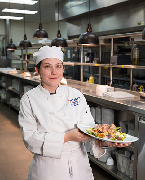 Culinary Arts student showing her plated dish.