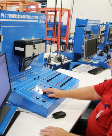 TSTC Industrial Systems instructor Brian Weakley demonstrates the programmable logic controller (PLC) troubleshooting system in the lab at TSTC’s Fort Bend County campus.