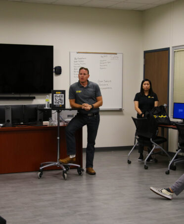 Mustang CAT-Energy Rental Solutions area operations manager James Yarbrough, center, tells TSTC HVAC students about the company during a recent visit to the Fort Bend County campus for an employer spotlight event.