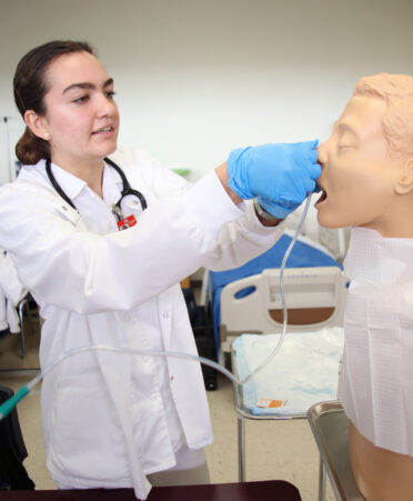 TSTC Vocational Nursing student Erin Gordon inserts a nasal gastric tube through a medical manikin’s nose to gather samples for testing purposes during a recent lab session.