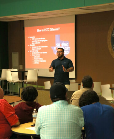 Robbie Mesa, director of dual enrollment at TSTC’s Harlingen campus, speaks during a recent recruitment presentation to some high school students of South Texas ISD’s Science Academy and their parents about the Computer Programming Technology classes that will be offered online through a dual enrollment P-TECH partnership in the fall 2023 semester.