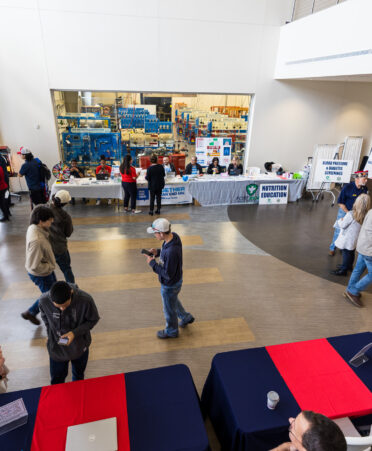 TSTC students mingle and interact with booths near the entrance of the resource fair in the ITC building.