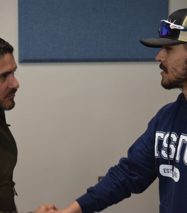 Jose Canales (left), a member of American Electric Power Texas’ work management team, visits with Jesse Baeza, a TSTC Electrical Power and Controls student, following an employer spotlight in Abilene.