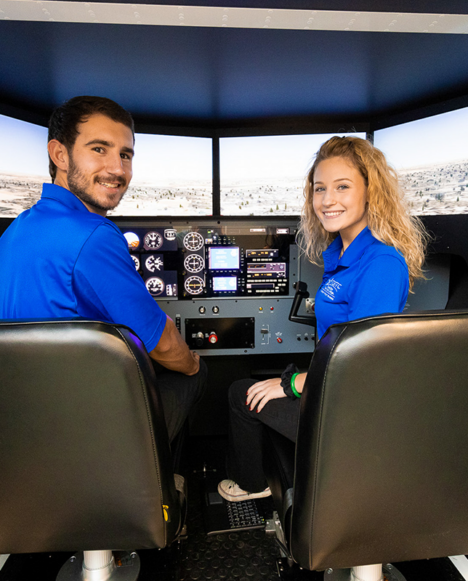 Two TSTC students posing in flight simulator123