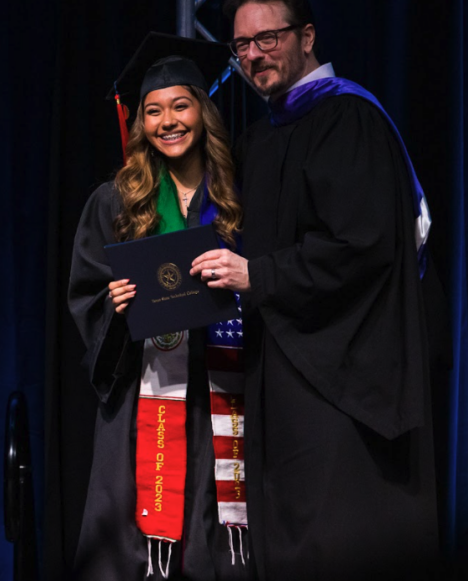 Fort Bend County graduate, Daniela, accepting her diploma.