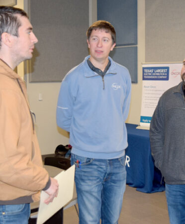 Oncor Electric Delivery Co. designers Scott Kopenitz (center) and Derek Conner (right) talk with TSTC Electrical Power and Controls student Antonio Dinovo following a recent employer spotlight.