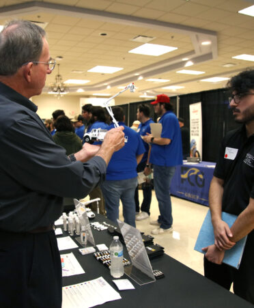 TSTC Mechatronics Technology student Daniel Flores (right) visits with John Sherman, talent pipeline development manager for Altec, at the recent Industry Job Fair held at TSTC’s Harlingen campus.