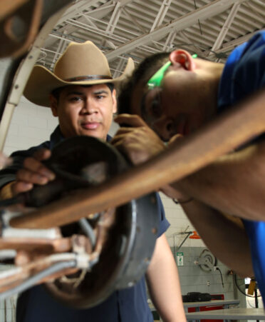 New TSTC Automotive Technology instructor Leo Tamez (left) observes student Sergio Mendoza while he removes a drum brake from a vehicle during a recent lab session.