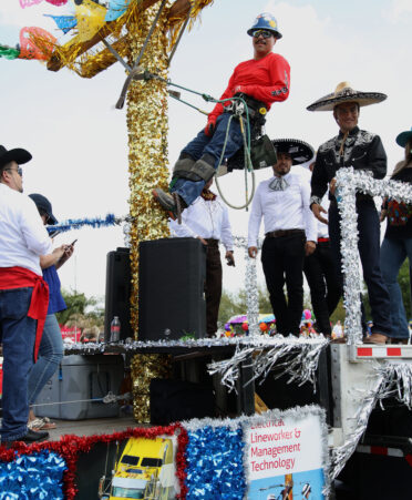 Some students from TSTC’s Electrical Lineworker and Workforce Training and Continuing Education programs wave to parade-goers at the recent Charro Days festival in Brownsville.