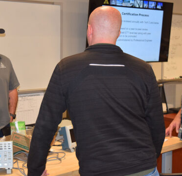 Justin Labay, a field supervisor for Dashiell Corp., discusses job opportunities with TSTC Electrical Power and Controls students during a recent visit to the Abilene campus.