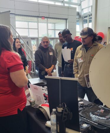 A company representative talks with students about their job openings