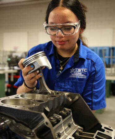 TSTC Automotive Technology student Gissela Hernandez Guzman installs a piston into a motor engine during a recent lab session.