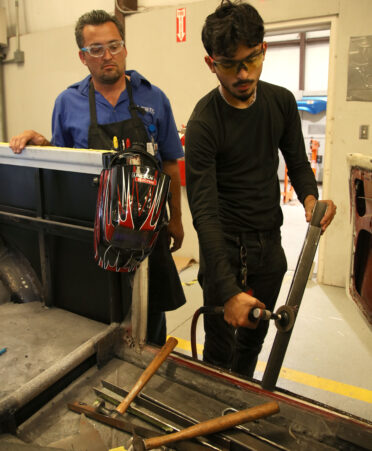 Diego Lopez (right), a TSTC Auto Collision and Management Technology student, prepares to weld a rocker panel onto a quarter panel on a 1927 Durant touring car while Jesus Reyna, a TSTC Auto Collision instructor, observes his technique during a recent lab session.