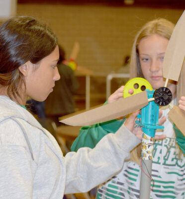 Floydada Collegiate Junior High School students Addison Hinson (left) and Madison Pyle work together on a wind turbine design during the KidWind West Texas Competition at TSTC’s Sweetwater campus. The team qualified for the national championship next month in Boulder, Colorado.