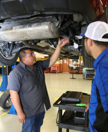 Juan Avila (left), a TSTC Automotive Technology instructor, explains the purpose of a dial indicator to student Thomas Reyes during a recent lab session.