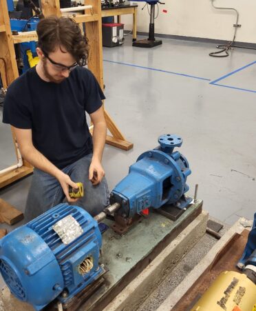 A student works on a small motor.