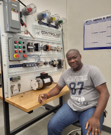 Ismael Diabate sits in front of training equipment.