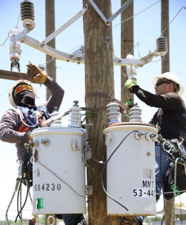 TSTC Electrical Lineworker and Management Technology students Richard Moreno (left) and Aaron Moreno connect wires to delta-wye transformers during a recent lab session.