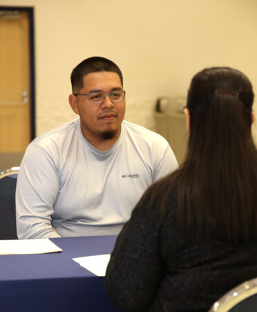 George Gomez, a TSTC Electrical Lineworker and Management Technology student, discusses his job qualifications with Maribel Land, brand manager for Rally Credit Union, during a recent TSTC Career Services Interview Practicum.