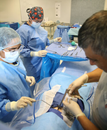 TSTC Surgical Technology alumnus Juan Alanis Jr. (right), a licensed surgical assistant for Valley Baptist Medical Center, recently guided students Arlen Vargas (left) and Jael Sigala through a mock surgical procedure during his visit as a guest speaker.