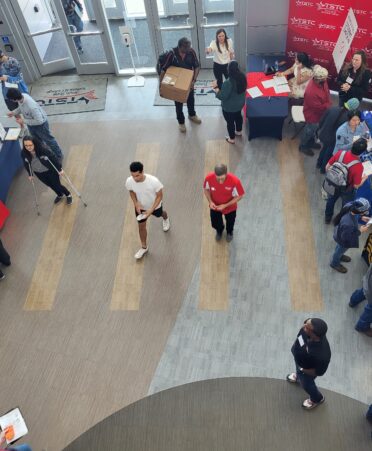 Overhead view of students and employers meeting at various booths.