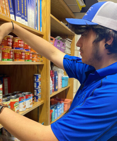 Sterling Hernandez, a Wind Energy Technology student at TSTC, restocks the food pantry at the Sweetwater campus. Earlier this year, the Winds of Texas, under the leadership of Axel Torres, donated $250 to restock the pantry.