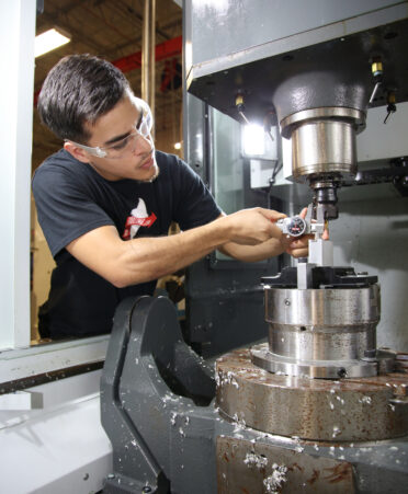 TSTC Precision Machining Technology student Rene Garay Jr. trains on a computer numerical control (CNC) 5-axis machine during a recent lab session at the Harlingen campus.