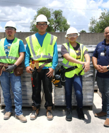 (Left to right) TSTC Building Construction Technology students Rolando Garcia, Luis Felipe Torres and Jadynn Ontiveros, with program director Hector Rosa, stand next to recently donated concrete masonry units from Best Block.