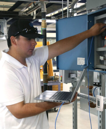 TSTC HVAC Technology student Sadrik-Joe Trevino connects an ethernet cable to a JACE controller during a recent lab session.