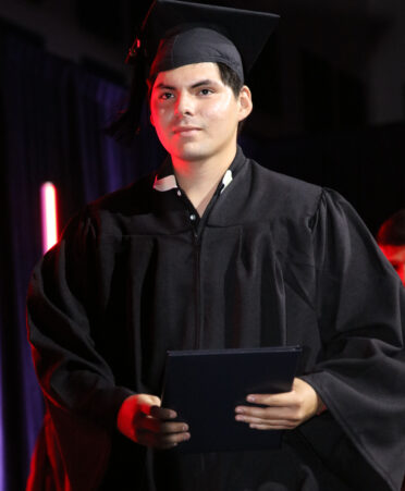 Allan Jurado walks the stage after accepting his certificate of completion in Precision Machining Technology at TSTC’s Summer 2023 Commencement on Aug. 22.