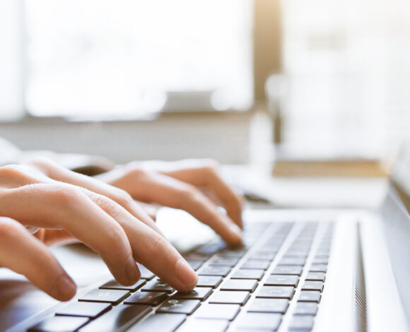 hands typing on a keyboard