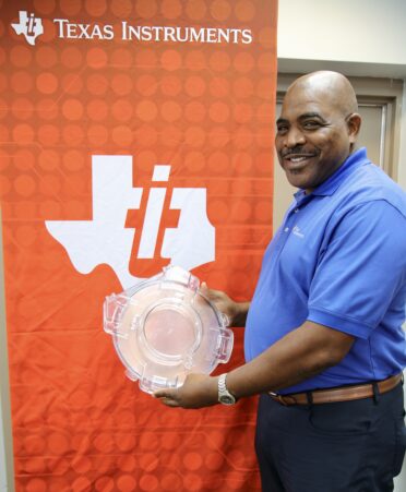 Texas Instruments equipment engineer Jimmy Carter displays a 300-millimeter wafer manufactured by the company, which he represented during a recent employer spotlight at Texas State Technical College’s Marshall campus. (Photo courtesy of TSTC.)