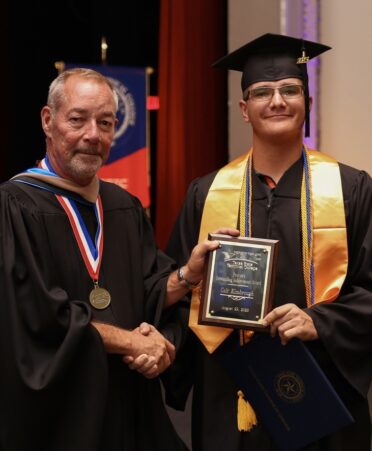 Recent TSTC graduate Colt Kimbrough (right) is handed the Provost’s Outstanding Achievement Award by Marshall campus provost Barton Day. (Photo courtesy of TSTC.)