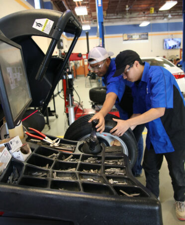 TSTC Automotive Technology students Cesar Eusebio (left) and Bryan Castillo use a wheel balancing system during a recent lab session.