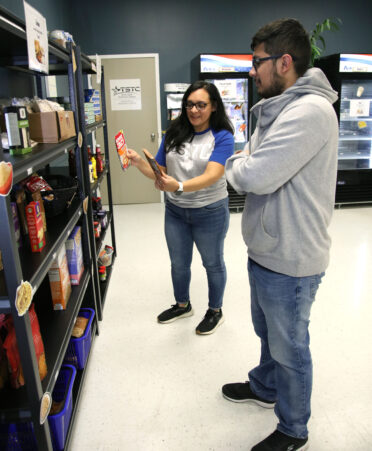 Cynthia Morley (left), a TSTC Advocacy and Resource Center coach, shows Lionel Del Rio, a TSTC Biomedical Equipment Technology student, some of the products that are available to choose from in the Advocacy and Resource Center’s food pantry at TSTC’s Harlingen campus.