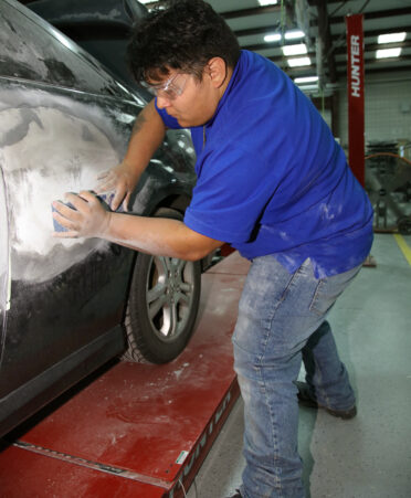 Daniel Pacheco, a TSTC Auto Collision and Management Technology student, repairs a dent on a 2006 Honda Accord during a recent lab session.