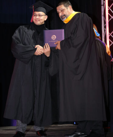 Photo caption: Jean-Ra Caballero (left) receives his Associate of Applied Science degree in Paramedic at TSTC’s Fall 2023 Commencement.