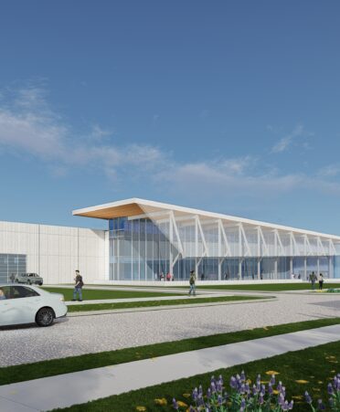 A rendering of the new Transportation Center of Excellence. A white car and some people sit in front.