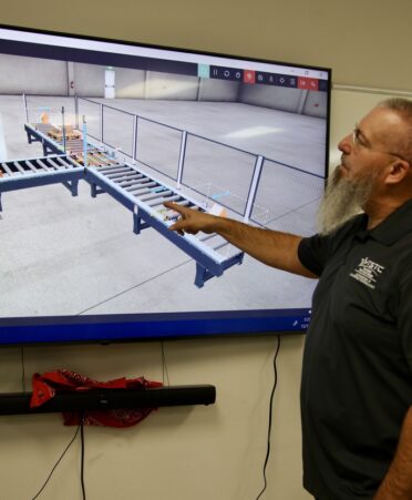 TSTC Automation and Controls Technology instructor Troy Powledge explains the virtual conveyor system that he and fellow instructor Douglas Clark built using Factory I/O. (Photo courtesy of TSTC.)