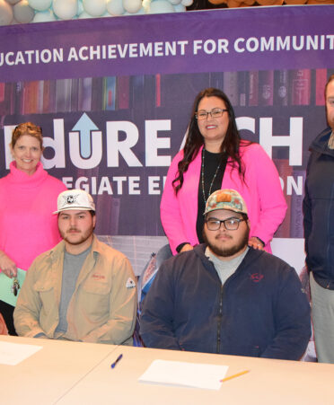 Six people at a signing ceremony