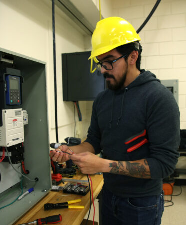 Emanuel Torres, a TSTC Mechatronics Technology student, prepares wiring for a motor-controlled panel during a recent lab session.